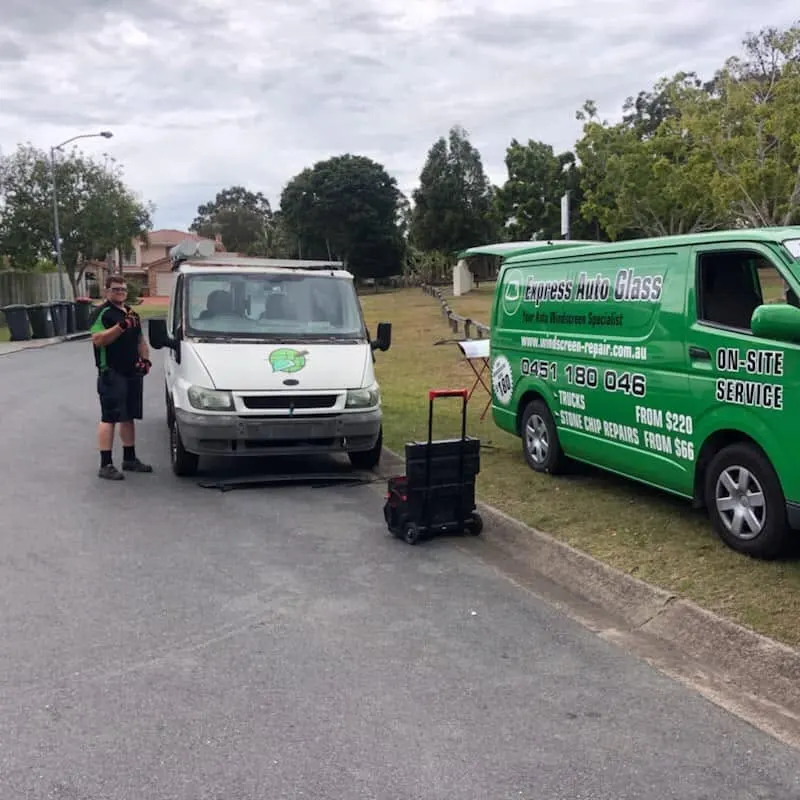 Express Auto Glass fitter and service van outside a home on a suburban street