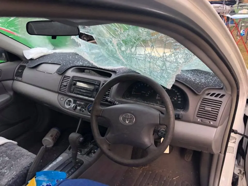 Smashed windscreen seen from inside a family car before an insurance replacement